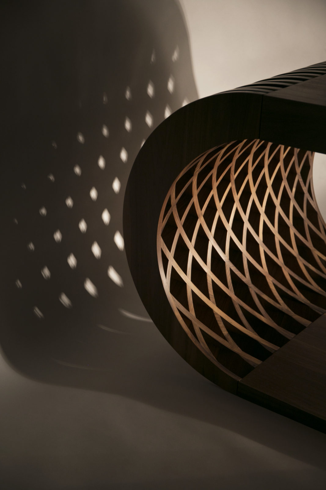 Criss-cross light pattern created by bespoke walnut desk