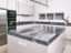 Matt lacquered pantry kitchen with Savana grey marble worktop