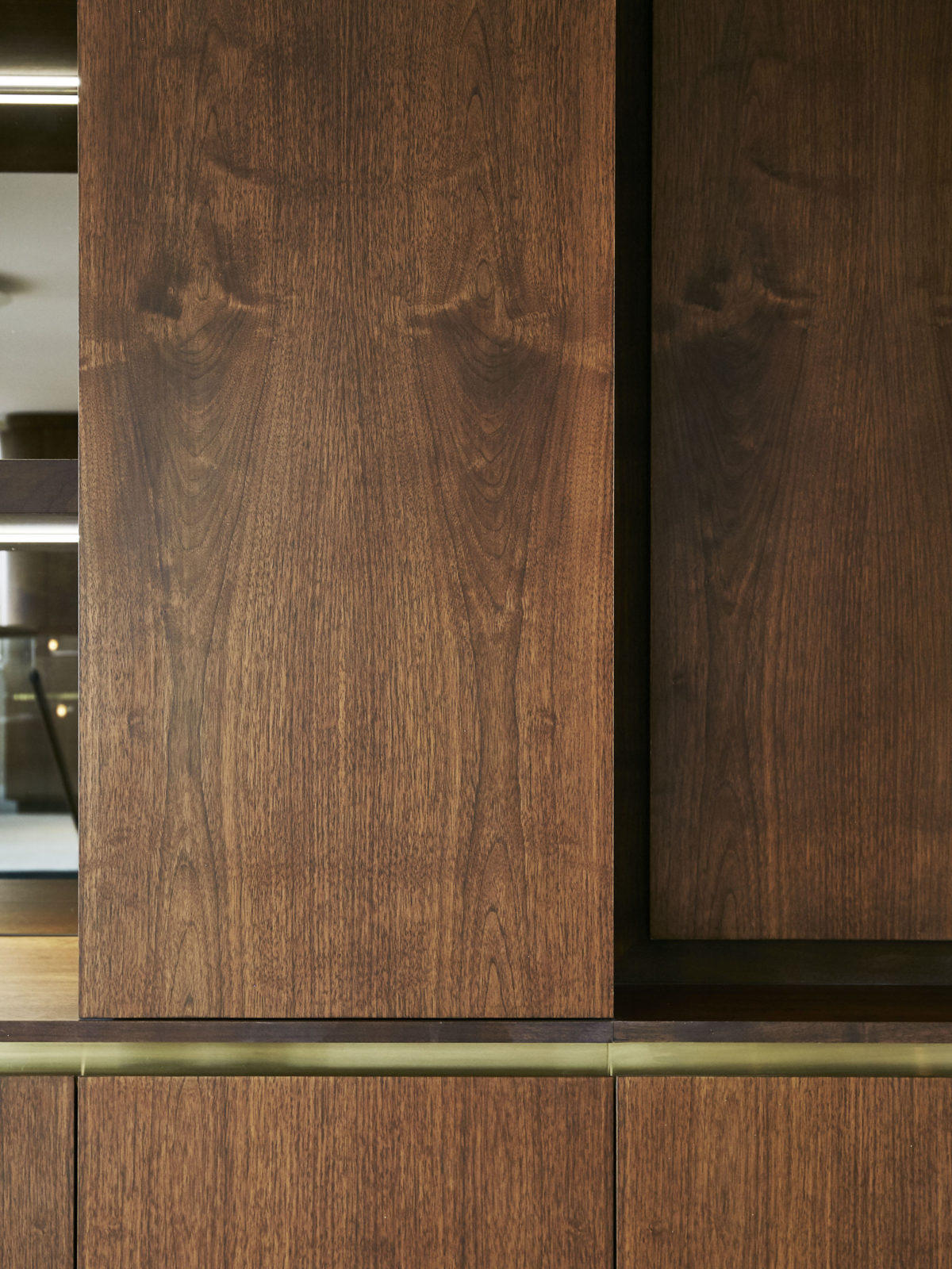 book matched walnut study cabinet with satin brass detail