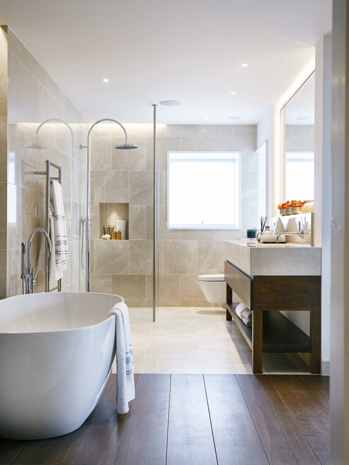 crema classic bathroom with walnut vanity unit and bathtub floor detail