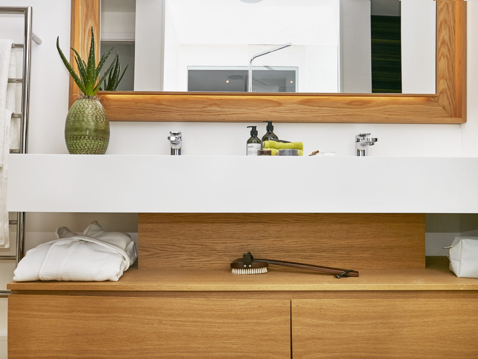 White Corian and oak bathroom