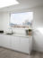 Handleless white matt lacquered kitchen