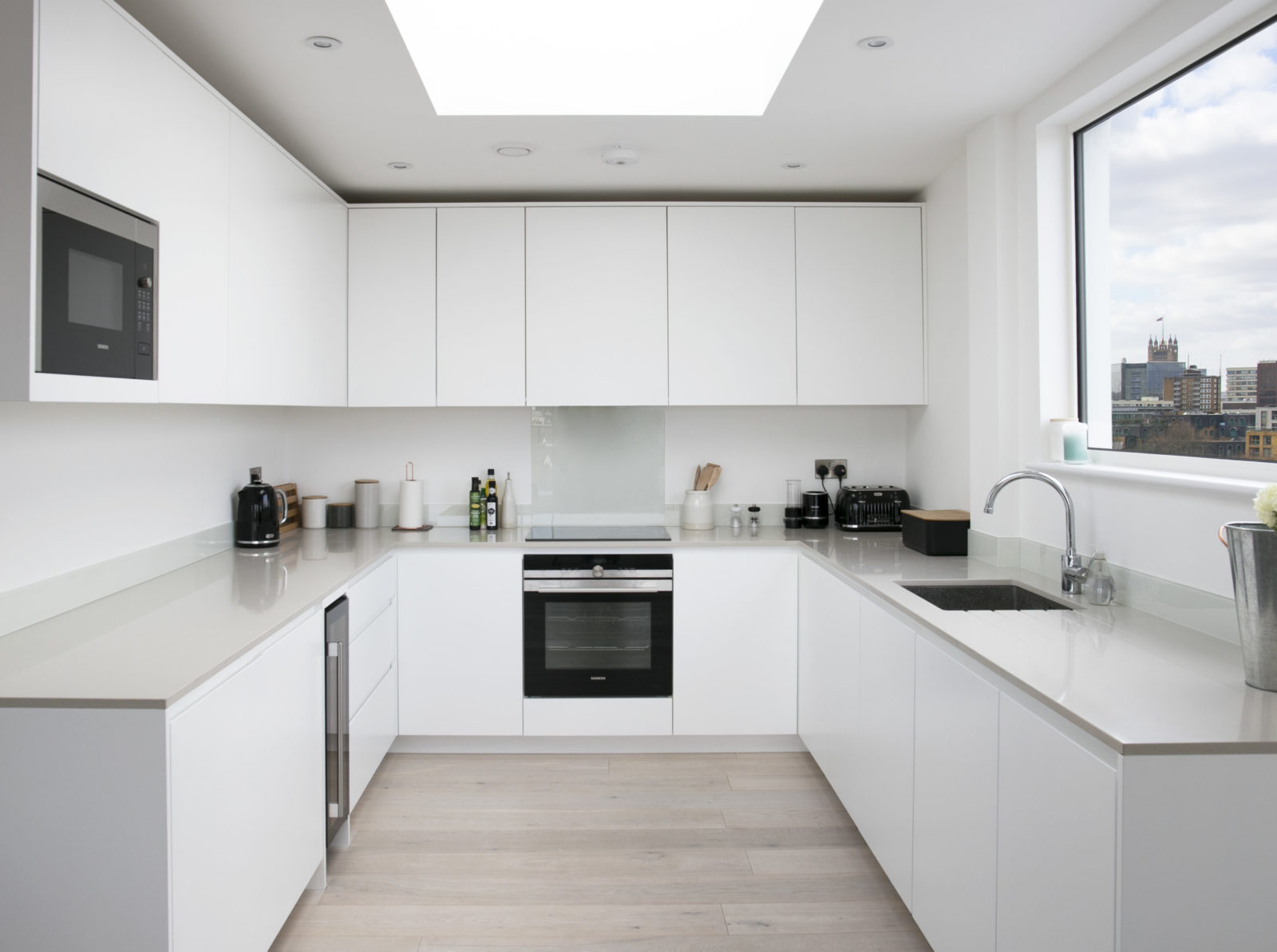 kitchen with matt white lacquered doors with Quartz worktop