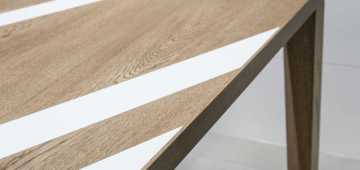 Oak dining table with white Corian inlays