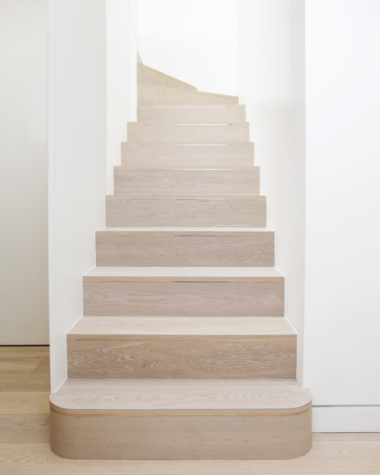 Limed oak staircase with rose gold inlay