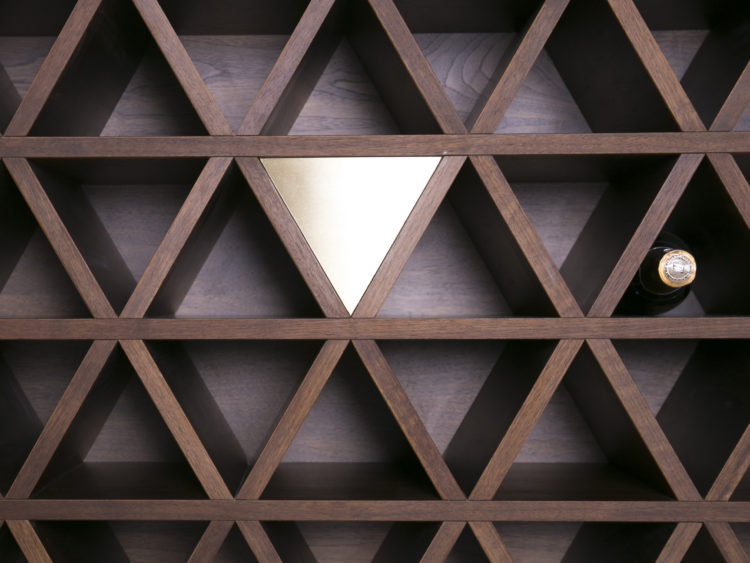 Solid walnut wine cellar wall with brass inserts