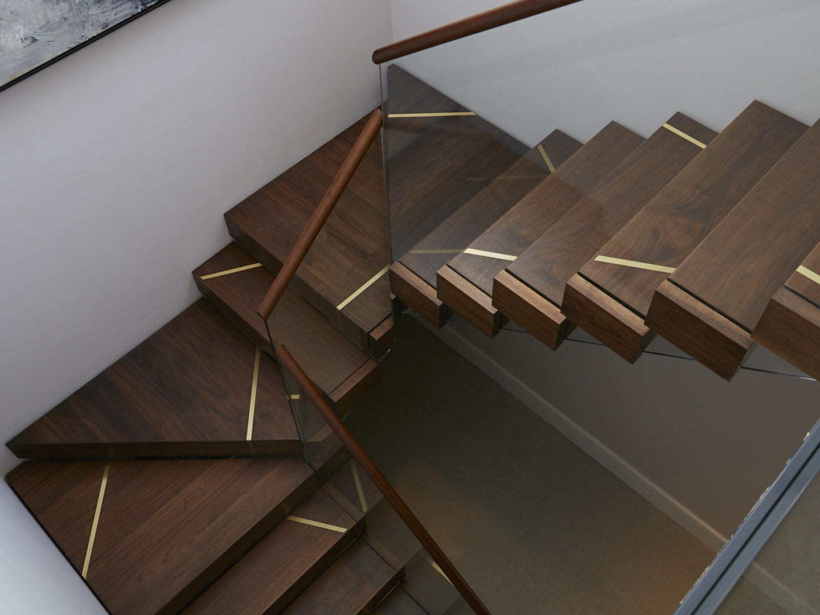 Solid walnut staircase with brass detailing